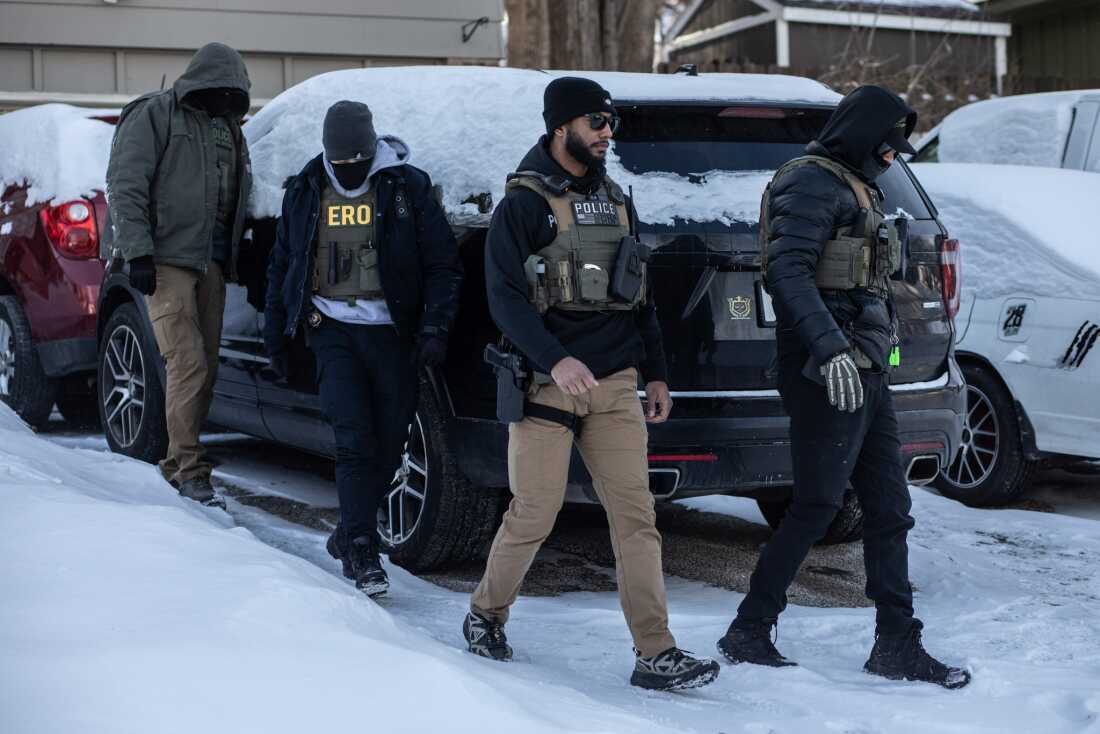 Ice agents outside a home in Minneapolis, Minnesota, Jan. 19, 2026.