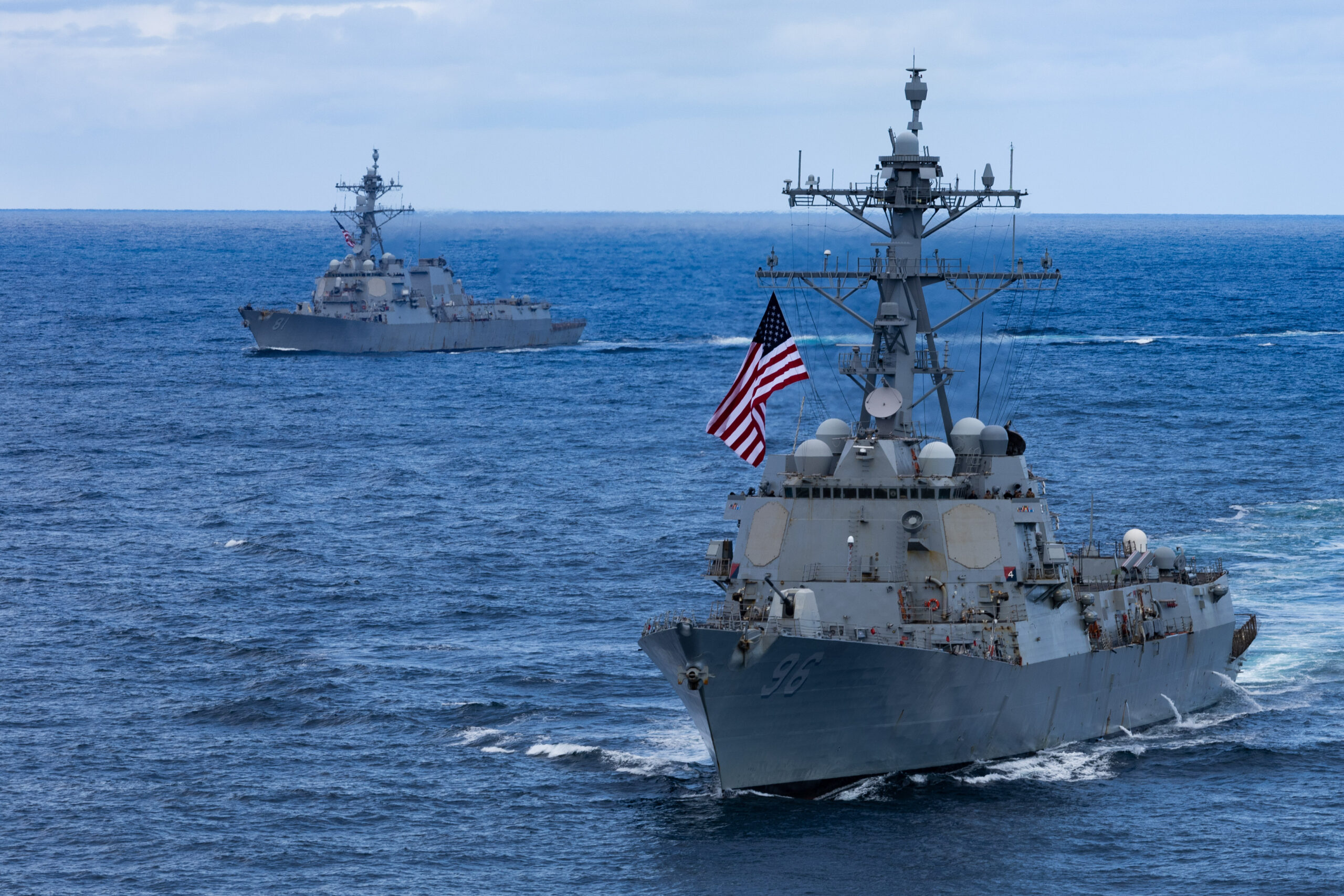 Arleigh Burke-class guided-missile destroyers USS Bainbridge (DDG 96) and USS Winston S. Churchill (DDG 81) sail in formation, Aug. 23, 2025. Carrier Strike Group Twelve is on a scheduled deployment in the U.S. 6th Fleet area of operations to support the warfighting effectiveness, lethality, and readiness of U.S. Naval Forces Europe-Africa, and defend U.S., Allied and partner interests in the region. (U.S. Navy photo by Mass Communication Specialist Seaman Apprentice Alyssa Joy)