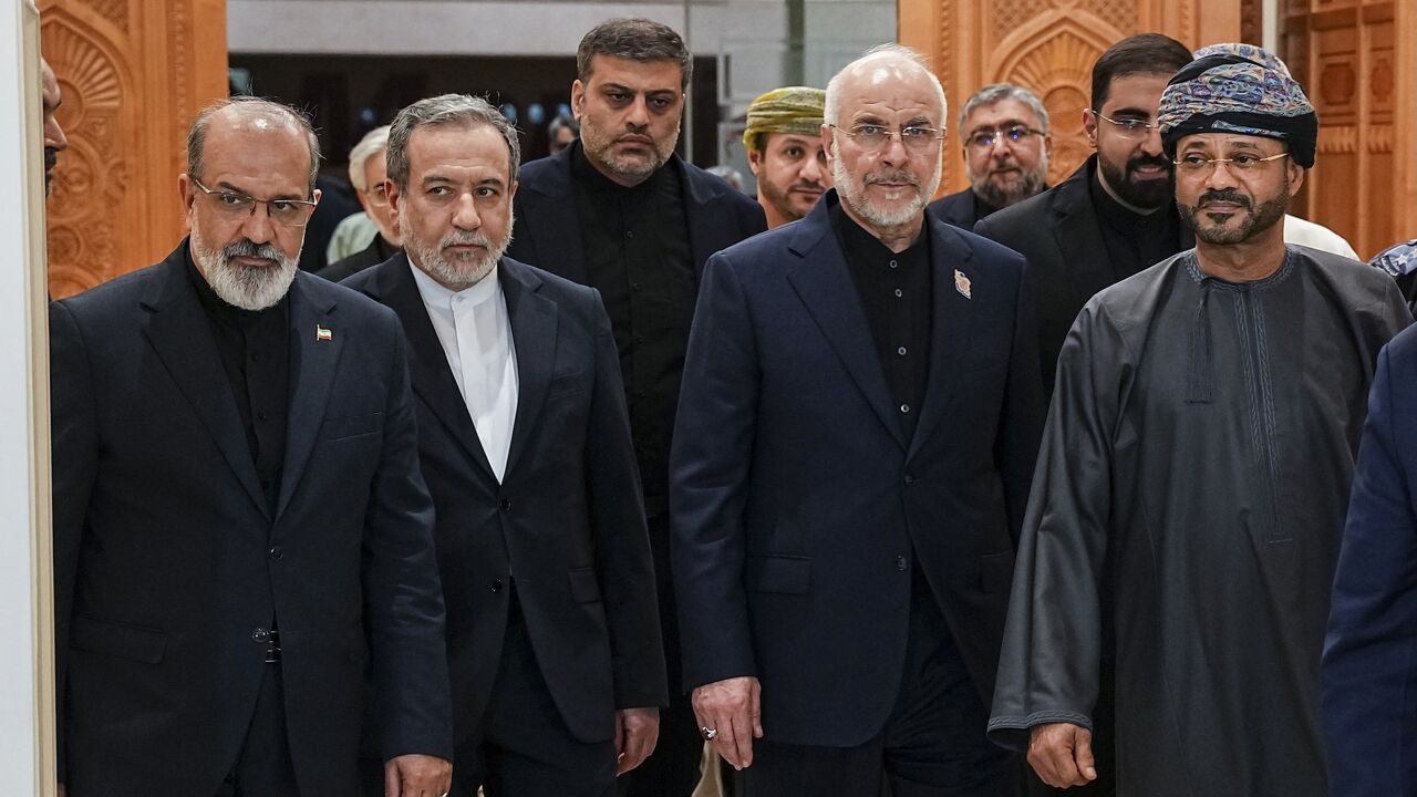 Iranian Foreign Minister Abbas Araghchi (2nd L), Iranian parliament speaker Mohammad Bagher Ghalibaf (2nd R), and Omani Foreign Minister Badr bin Hamad Al Busaidi (R) walk inside a building in Muscat, Oman, on June 22, 2026. Ghalibaf, head of the Iranian delegation, traveled to Oman alongside Araghchi to discuss bilateral cooperation and the stabilization of Iranian arrangements in managing the Strait of Hormuz. (Photo by Hamed Malekpour / Middle East Images via AFP)