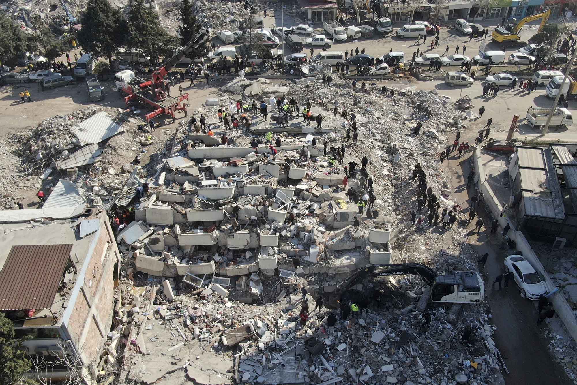 Aerial photo shows the destruction in Kahramanmaras city center, southern Turkey, Thursday, Feb. 9, 2023. Thousands who lost their homes in a catastrophic earthquake huddled around campfires and clamored for food and water in the bitter cold, three days after the temblor and series of aftershocks hit Turkey and Syria. (IHA via AP)