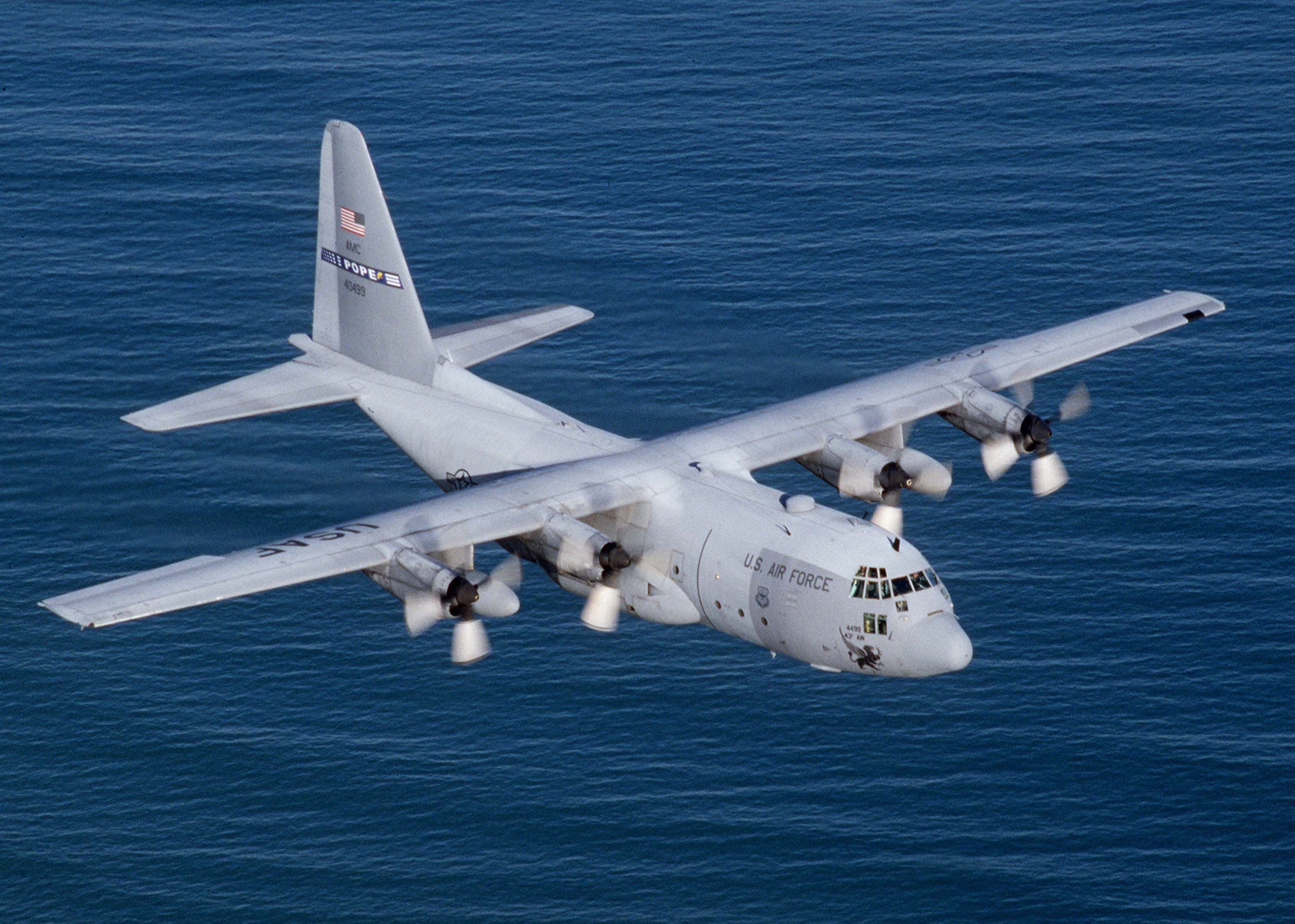 A C-130E from the 2nd Airlift Squadron, Pope AFB, N.C., flies over the Atlantic Ocean along the North Carolina coast. The C-130 Hercules primarily performs the intratheater portion of the airlift mission. The aircraft is capable of operating from rough, dirt strips and is the prime transport for paradropping troops and equipment into hostile areas. (U.S. Air Force photo by Tech. Sgt. Howard Blair) 