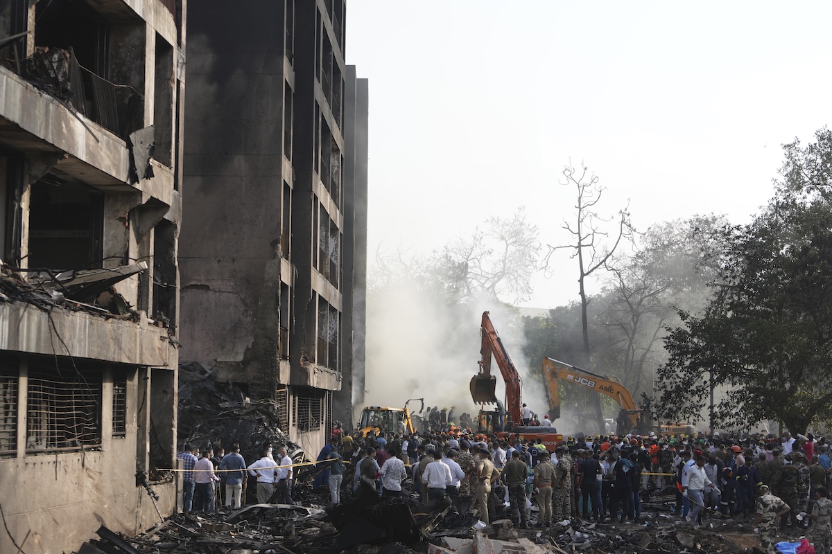Search and rescue teams respond to the scene of a plane crash in Ahmedabad, India, Thursday, June 12, 2025. (AP Photo/Ajit Solanki)  