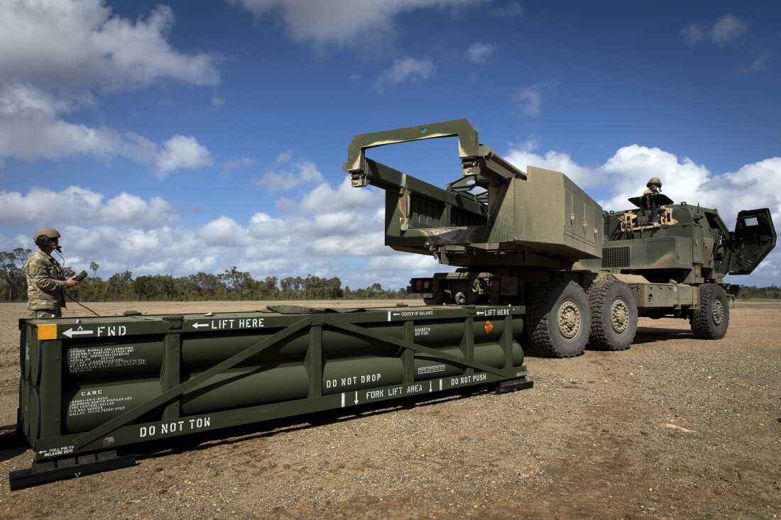 FILE - In this image provided by the U.S. Army, U.S. Army Sgt. Ian Ketterling, gunner for Alpha Battery, 1st Battalion, 3rd Field Artillery Regiment, 17th Field Artillery Brigade, prepares the crane for loading the Army Tactical Missile System (ATACMS) on to the High Mobility Artillery Rocket System (HIMARS) in Queensland, Australia, on July 26, 2023. (Sgt. 1st Class Andrew Dickson/U.S. Army via AP)