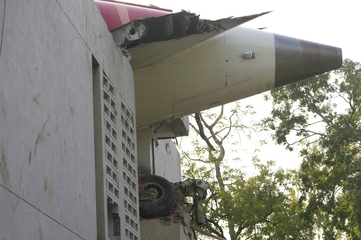 The debris of an airplane sticks out of a building after it crashed in India's northwestern city of Ahmedabad in Gujarat state, Thursday, June 12, 2025. (AP Photo/Ajit Solanki)