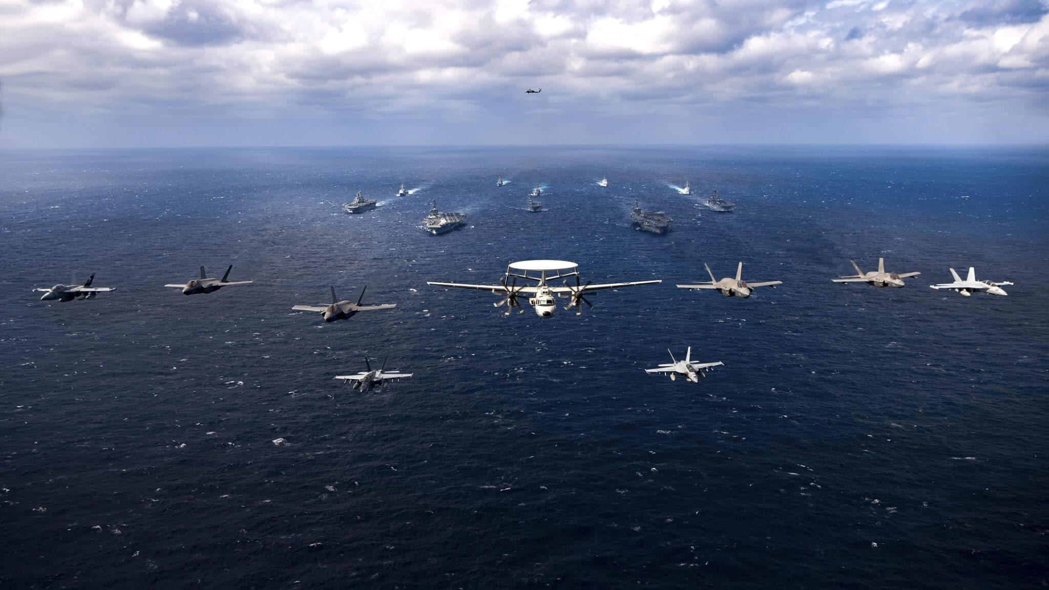 220122-N-HS181-1255 PHILIPPINE SEA (Jan. 22, 2022) Aircraft assigned to Carrier Air Wing (CVW) 2 and CVW 9 fly over the Philippine Sea Jan. 22, 2022. Operating as part of U.S. Pacific Fleet, units assigned to Carl Vinson and Abraham Lincoln Carrier Strike Groups, Essex and America Amphibious Ready Groups, and Japan Maritime Self-Defense Force are conducting training to preserve and protect a free and open Indo-Pacific region. (U.S. Navy photo by Mass Communication Specialist 2nd Class Haydn N. Smith)