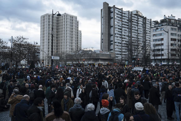 People gather on Italy square during a protest in Paris, Saturday, March 18, 2023. A spattering of protests were planned to continue in France over the weekend against President Macron's controversial pension reform, as garbage continued to reek in the streets of Paris and beyond owing to continuing action by refuse collectors. (AP Photo/Lewis Joly)