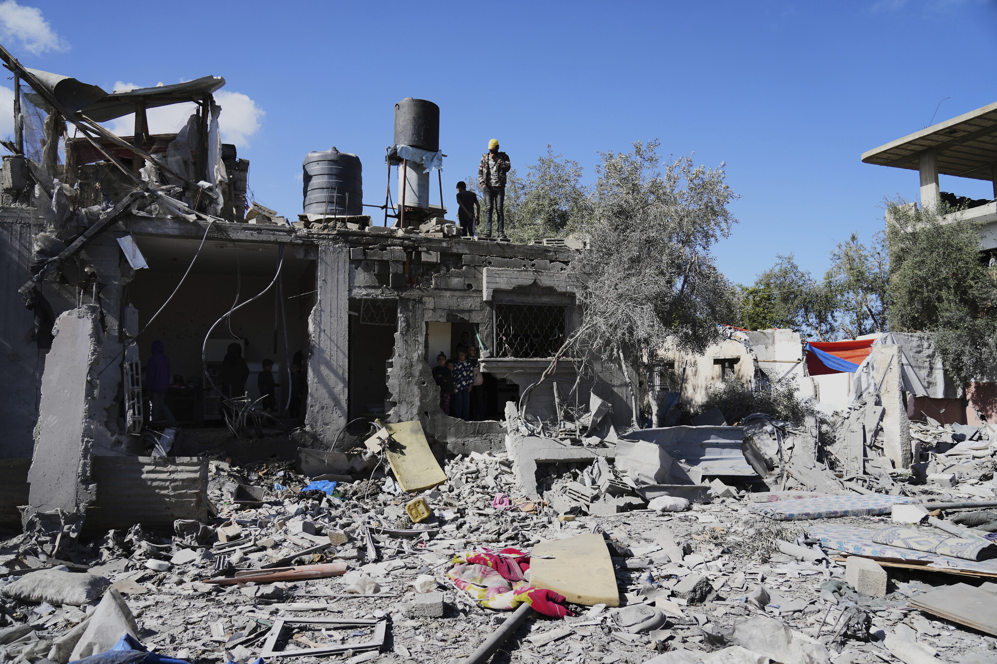 Palestinians inspect their damaged house following an Israeli bombardment in Deir al-Balah, Gaza Strip on Wednesday, March 19, 2025. (AP Photo/Abdel Kareem Hana)