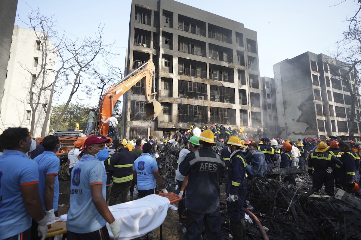 Search and rescue teams respond to the scene of a plane crash in Ahmedabad, India, Thursday, June 12, 2025. (AP Photo/Ajit Solanki)  
