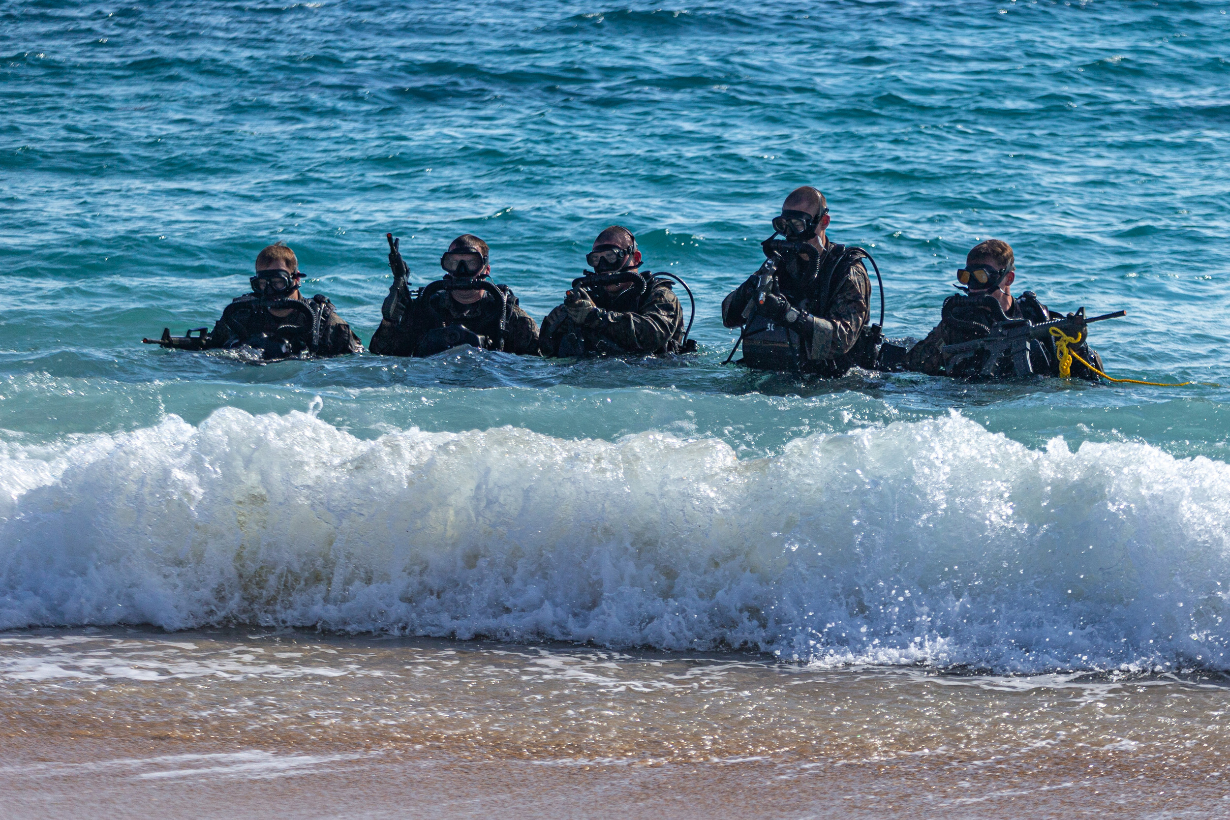 U.S. Marines with Force Reconnaissance Platoon (FRP), 31st Marine Expeditionary Unit (MEU), egress from the bay after dive operations during MEU exercise (MEUEX) on Kin Blue training area, Okinawa, Japan, Dec. 15, 2021. FRP conducted diving repetitions to maintain proficiency and currency as combatant divers. MEUEX is a pre-deployment training exercise that validates and reinforces the MEU’s mission capabilities across all of the Marine subordinate elements. The 31st MEU, the Marine Corps’ only continuously forward-deployed MEU, provides a flexible and lethal force ready to perform a wide range of military operations as the premier crisis response force in the Indo-Pacific region. (U.S. Marine Corps photo by Cpl. Grace Gerlach)
