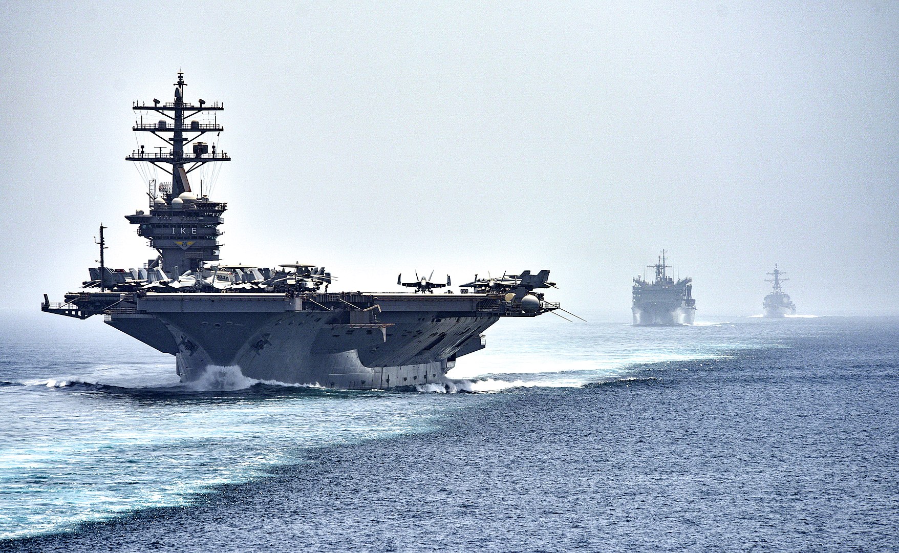 160721-N-OR652-449.STRAIT OF HORMUZ (July 21, 2016) The aircraft carrier USS Dwight D. Eisenhower (CVN 69), followed by the fast combat support ship USNS Arctic (T-AOE 8) and the guided-missile destroyer USS Nitze (DDG 94), transit the Strait of Hormuz. The Eisenhower Carrier Strike Group is deployed in support of maritime security operations and theater security cooperation efforts in the U.S. 5th Fleet are of operations. (U.S. Navy photo by Mass Communication Specialist 3rd Class J. Alexander Delgado/Released).