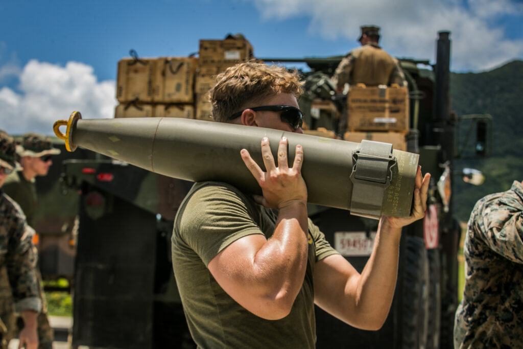 U.S. Marine Corps Cpl. Carter Hughes, a combat engineer with Alpha Company, 9th Engineer Support Battalion, 3d Marine Logistics Group, carries a 155mm artillery round while conducting explosive ordnance disposal operations on Range 10, Camp Schwab, Okinawa, Japan, July 13, 2021. Marines with 3d EOD Co. and Alpha Co. conducted EOD operations simulating the discovery and disposal of notional foreign unexploded ordnance. 3d MLG, based out of Okinawa, Japan, is a forward deployed combat unit that serves as III Marine Expeditionary Force’s comprehensive logistics and combat service support backbone for operations throughout the Indo-Pacific area of responsibility. Hughes is a native of Salt Lake City, Utah. (U.S. Marine Corps photo by Sgt. Hailey D. Clay)