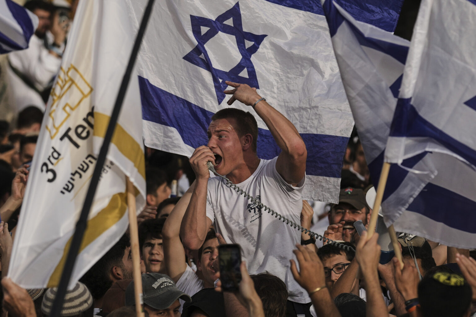 Israelis wave national flags during a march marking Jerusalem Day, an Israeli holiday celebrating the capture of east Jerusalem in the 1967 Mideast war, in Jerusalem's Old City, Monday, May 26, 2025. (AP Photo/Leo Correa)