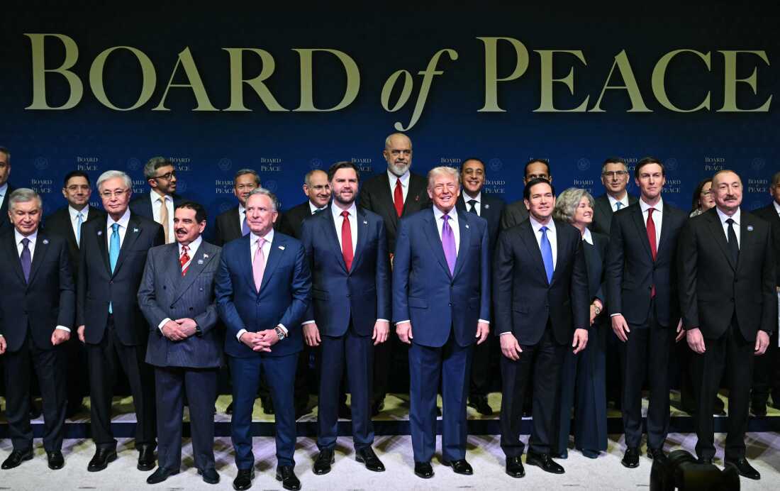 US President Donald Trump (C), flanked by US Vice President JD Vance (L) and US Secretary of State Marco Rubio (R), joins leaders for a group photo during the inaugural meeting of the "Board of Peace" at the US Institute of Peace in Washington, DC, on February 19, 2026. President Trump on Thursday gathers allies to inaugurate the "Board of Peace," his new institution focused on progress on Gaza but whose ambitions reach much further. Around two dozen world leaders or other senior officials have come to Washington for the meeting -- including several of Trump's authoritarian-leaning friends and virtually none of the European democrats that traditionally sign on to US initiatives. (Photo by SAUL LOEB / AFP)