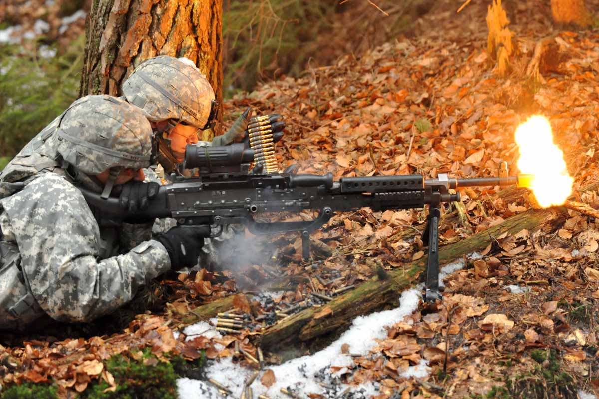 U.S. Army Pvt. Alex Hernandez (front) and Spc. Justin Huser, both from Ghost Company, 3rd Squadron, 2nd Cavalry Regiment, Vilseck, Germany, fire their M240 machine gun during a Fire Team and Squad level Situational Training Exercise focused on react to contact, attack, and break contact in the Grafenwoehr Training Area, Germany, Feb. 23, 2012.