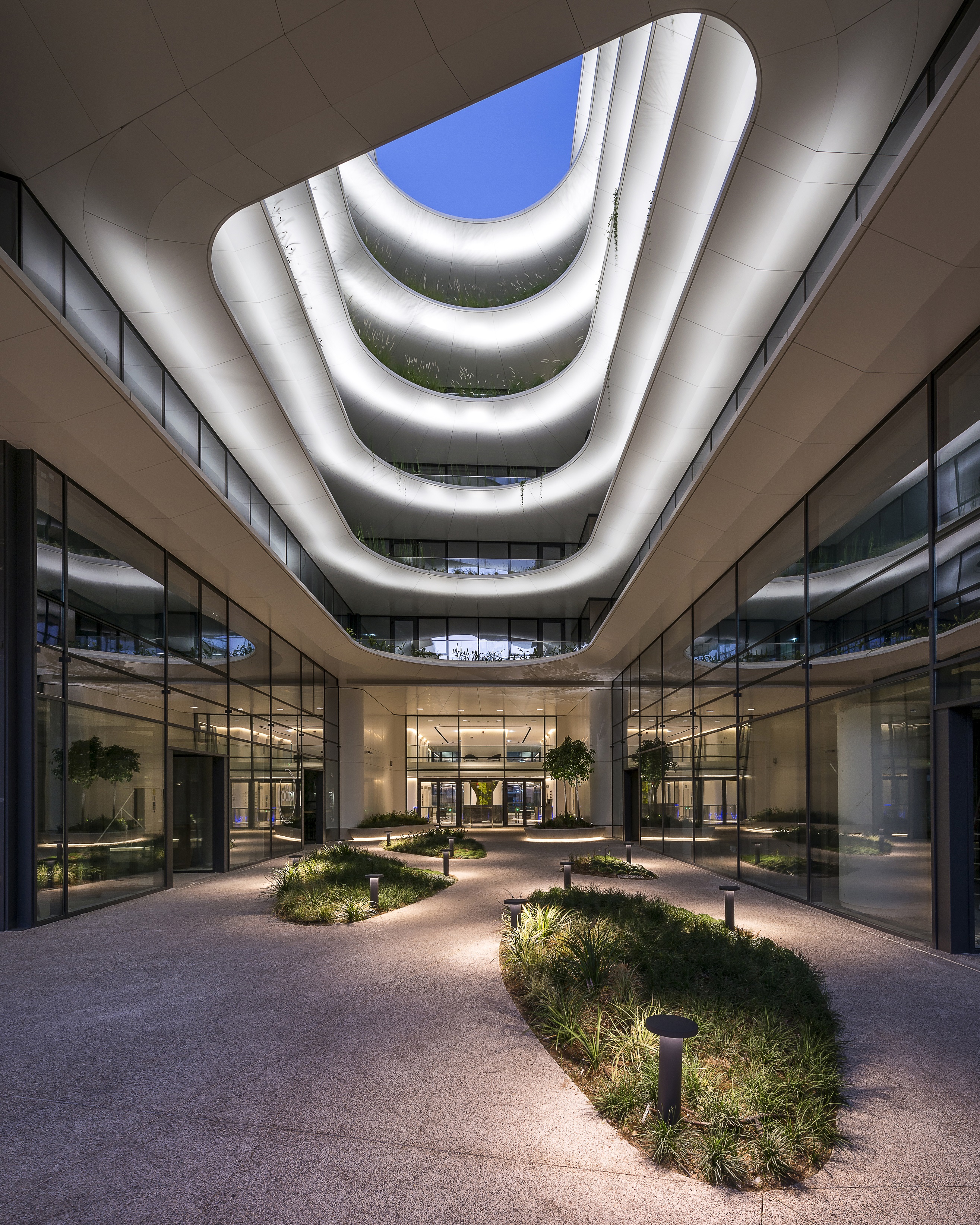 Exterior view of entrance atrium, The Orbit - Urban Office Campus, Athens Greece, lighting design by Danilof Light + Visual Perception Studio | architecture by LC Architects &amp; Vikelas Architects, photographed by © Pygmalion Karatzas.