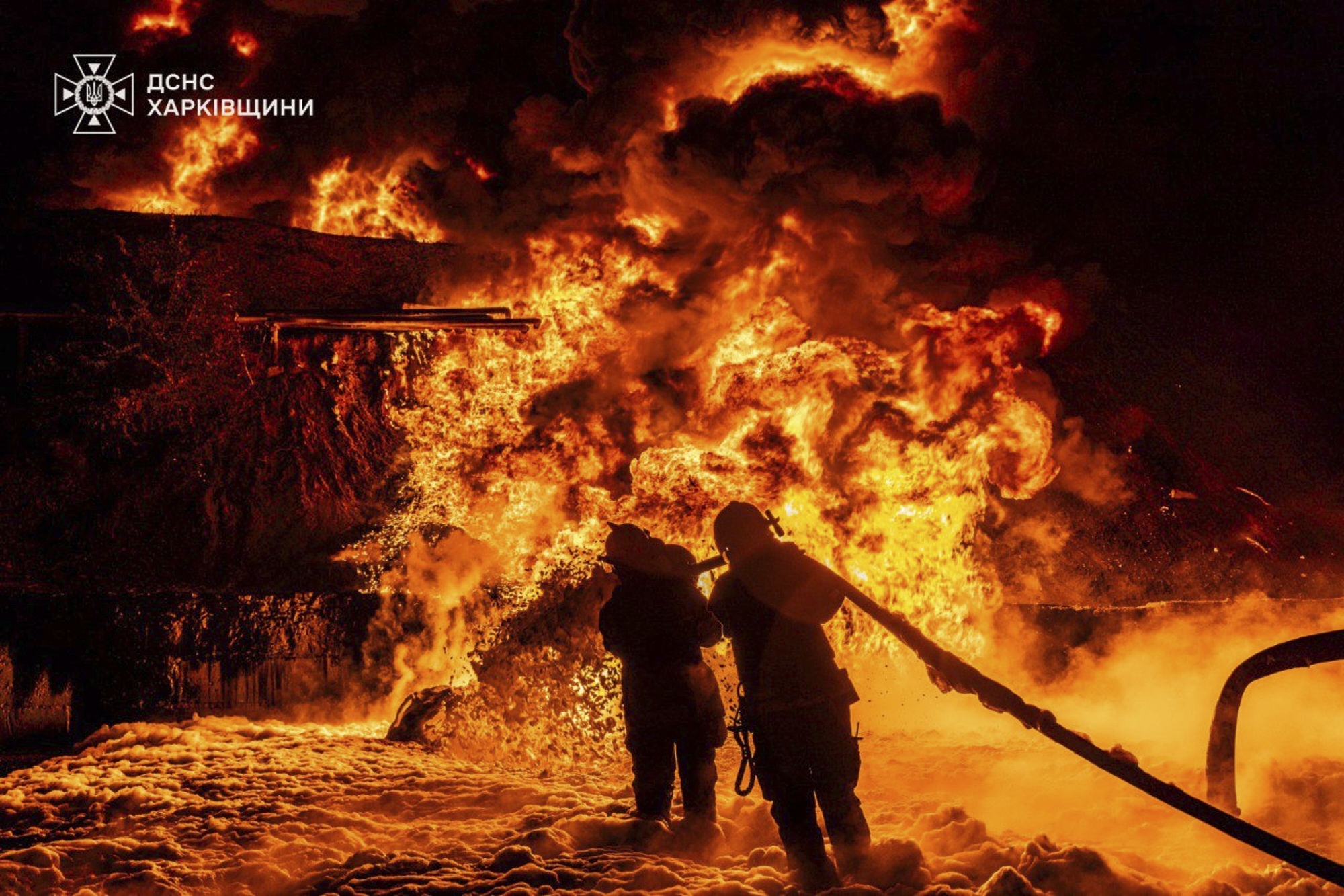 In this photo provided by the Ukrainian Emergency Service, emergency services personnel work to extinguish a fire following a Russian attack in Kharkiv region, Ukraine, Saturday, July 5, 2025. (Ukrainian Emergency Service via AP)