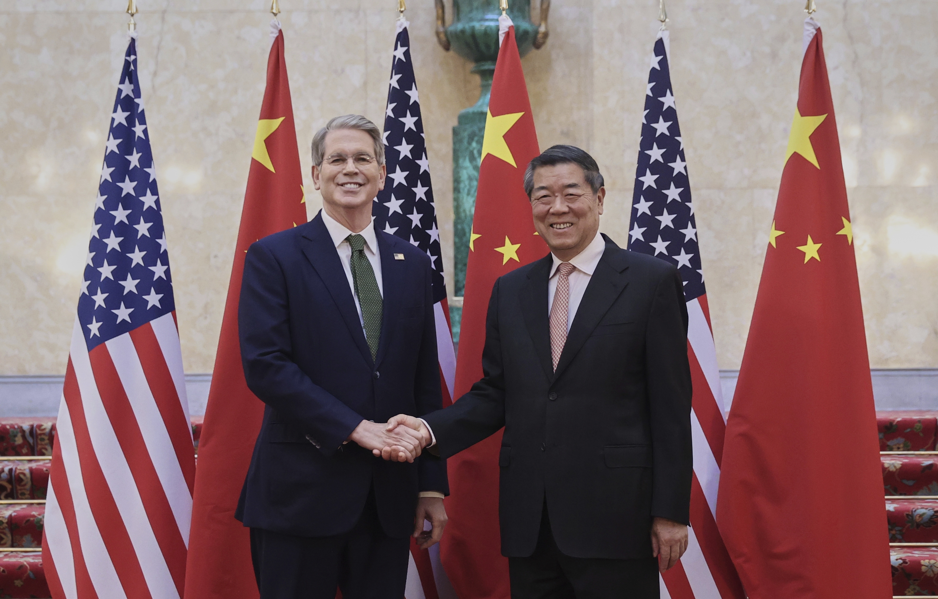 In this photo released by Xinhua News Agency, Chinese Vice Premier He Lifeng, right, shakes hands with U.S. Treasury Secretary Scott Bessent before their meeting to discuss China-U.S. trade, in London, Monday, June 9, 2025. (Li Ying/Xinhua via AP)