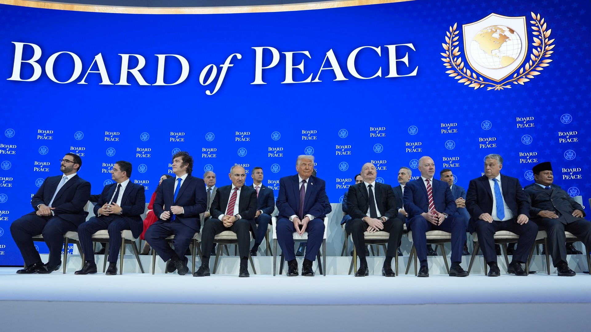 President Donald Trump, center, poses with international leaders after the signing of a Board of Peace charter during the Annual Meeting of the World Economic Forum in Davos, Switzerland, Thursday, Jan. 22, 2026. (AP Photo/Evan Vucci)