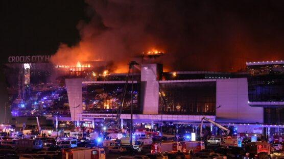 Emergency services vehicles are seen outside the burning Crocus City Hall concert hall following the shooting incident in Krasnogorsk, outside Moscow, on March 22, 2024. Gunmen opened fire at a concert hall in a Moscow suburb on March 22, 2024 leaving dead and wounded before a major fire spread through the building, Moscow's mayor and Russian news agencies reported. (Photo by STRINGER / AFP)