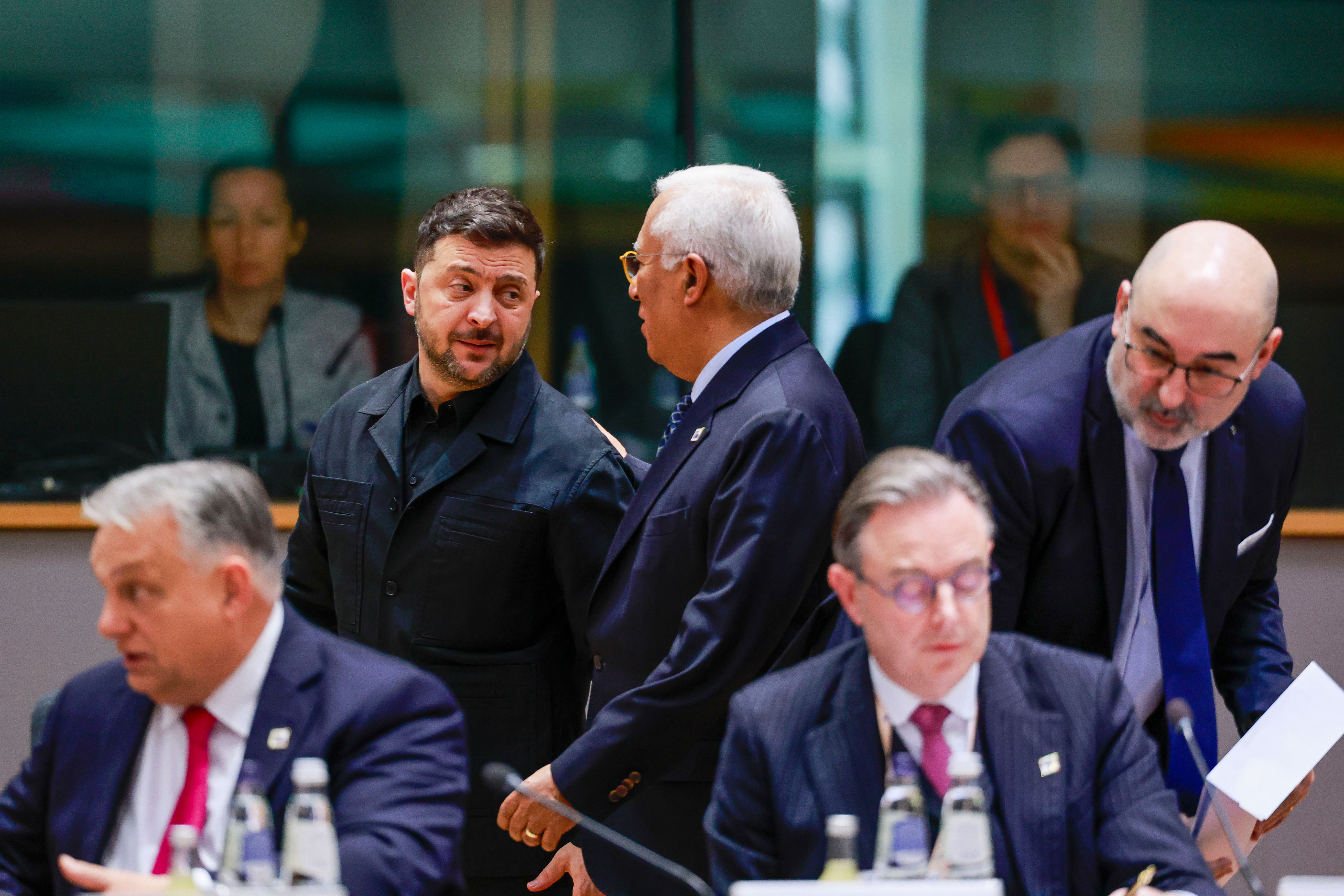 Ukraine's President Volodymyr Zelenskyy, second left, speaks with European Council President Antonio Costa, center rear, during a round table meeting at the EU Summit in Brussels, Thursday, Dec. 18, 2025. (Stephanie Lecocq, Pool Photo via AP)