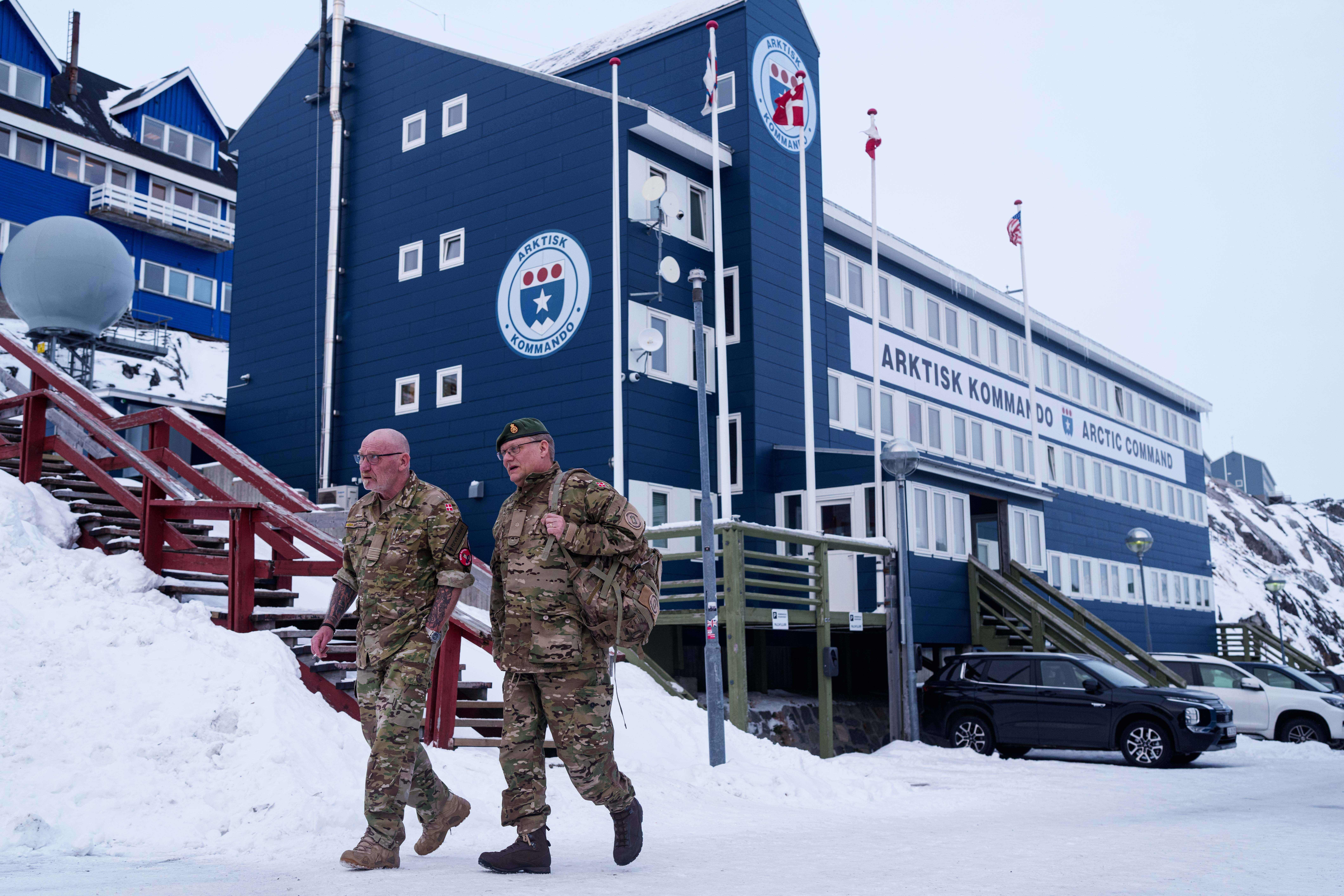 Danish servicemen walk in front of Joint Arctic Command center in Nuuk, Greenland, on Friday, Jan. 16, 2026. (AP Photo/Evgeniy Maloletka)
