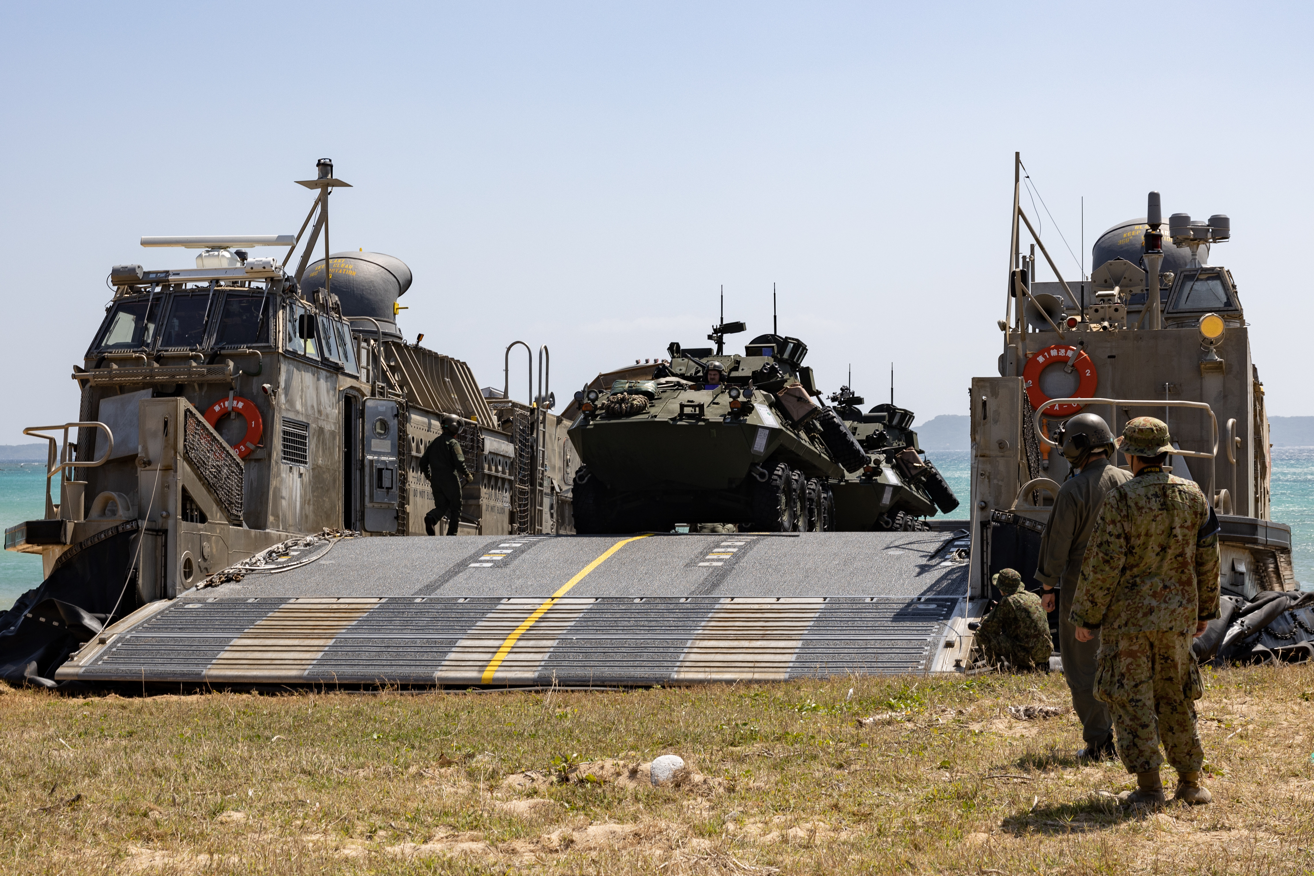 Japan Maritime Self-Defense Force landing craft, air cushion (LCAC) pilots, prepare to disembark U.S. Marine Corps light armored vehicle crewmen with Battalion Landing Team 1/1, 31st Marine Expeditionary Unit, during an amphibious landing exercise, part of Iron Fist 24, at Kin Blue, Okinawa, Japan, Mar. 12, 2024. The 31st MEU is ready to respond to crisis throughout the region with the entire range of military operations to support and defend our allies and partners in the region. Iron Fist is an annual bilateral exercise designed to increase interoperability and strengthen the relationships between the U.S. Marine Corps, the U.S. Navy, the Japan Ground Self Defense Force, and the Japan Maritime Self-Defense Force. (U.S. Marine Corps photo by Cpl. Christopher Lape)