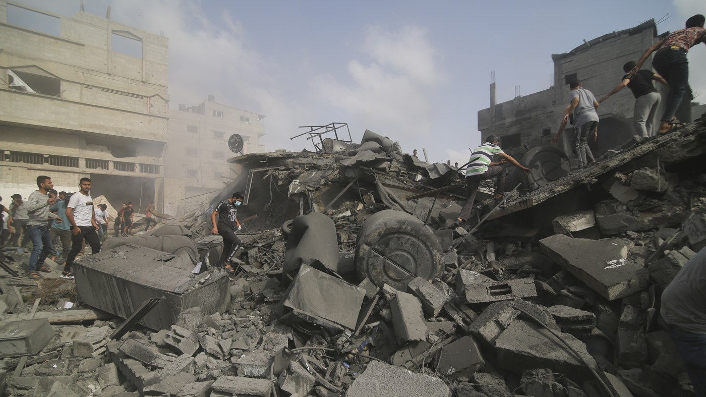 Palestinians look for survivers in buildings destroyed in the Israeli bombardment of the Gaza Strip in Rafah, Sunday, Oct. 22, 2023. (AP Photo/Hatem Ali)