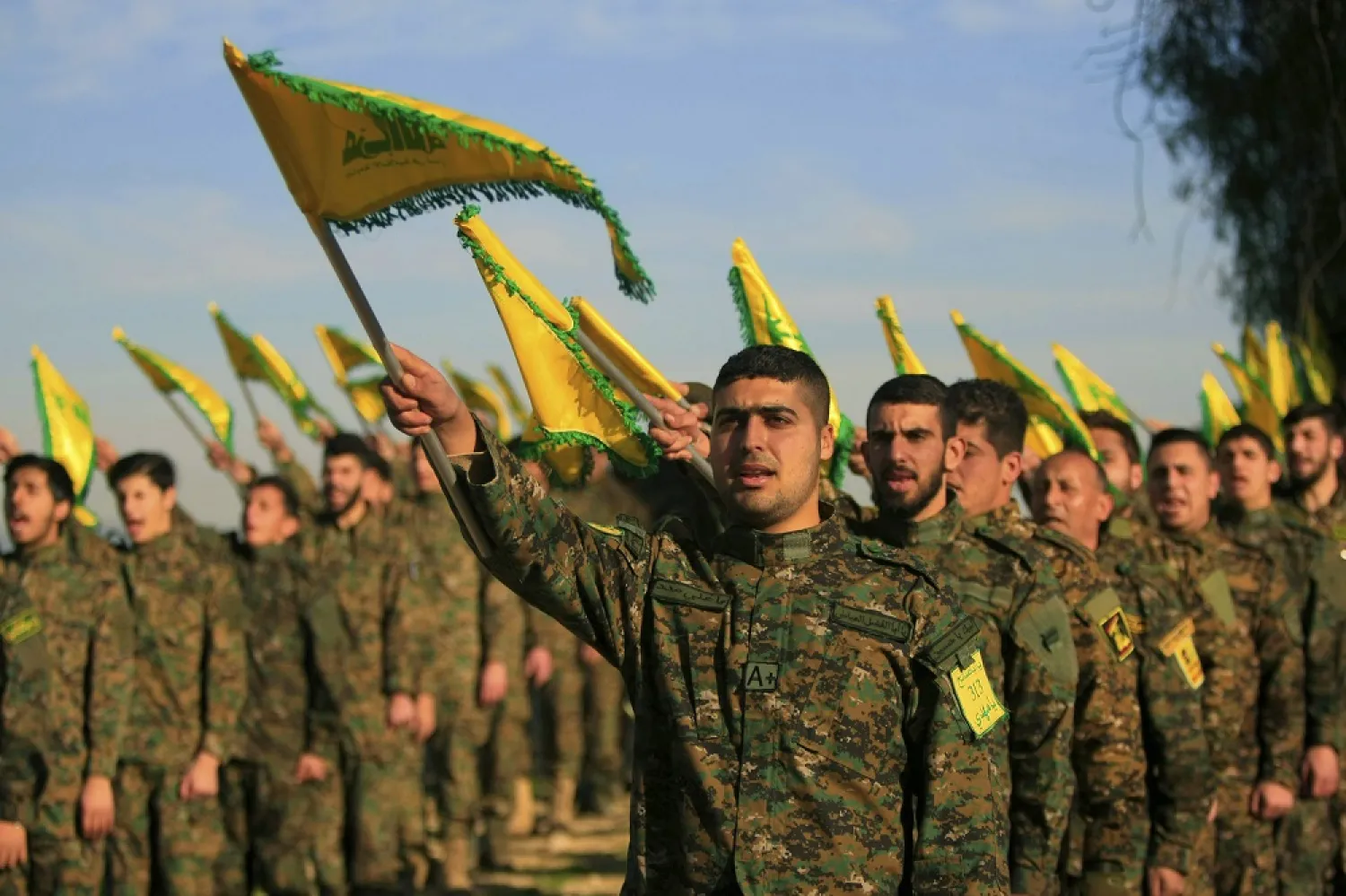 hezbollah_fighters_hold_flags_as_they_attend_the_memorial_of_their_slain_leader_sheikh_abbas_al-mousawi_in_tefahta_village_south_lebanon_on_feb._13_2016._ap.jpg.webp