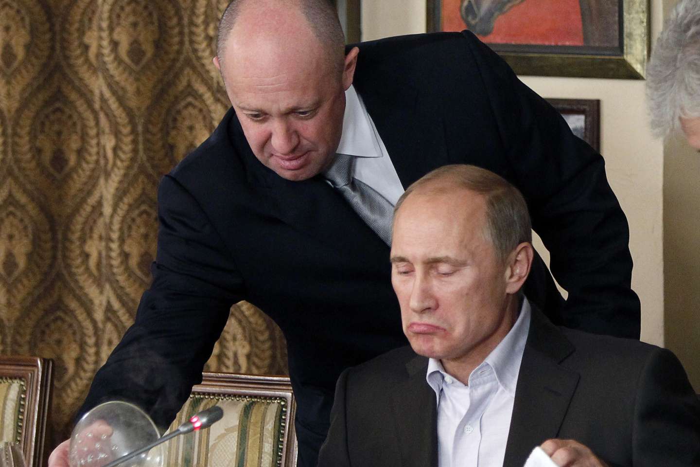 FILE Yevgeny Prigozhin, top, serves food to then-Russian Prime Minister Vladimir Putin at Prigozhin's restaurant outside Moscow, Russia on Nov. 11, 2011. Prigozhin, the owner of the Wagner private military contractor who called for an armed rebellion aimed at ousting Russia's defense minister has confirmed in a video that he and his troops have reached Rostov-on-Don. (AP Photo, File)