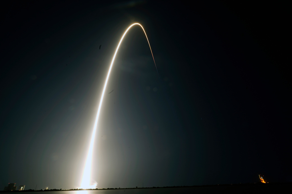 FILE - In this time-exposure photograph, a SpaceX Falcon 9 rocket with the 25th batch of approximately 60 satellites for SpaceX's Starlink broadband network lifts off from the Space Launch Complex 40 at the Cape Canaveral Space Force Station in Cape Canaveral, Fla., late Wednesday, April 28, 2021. (AP Photo/John Raoux, File)