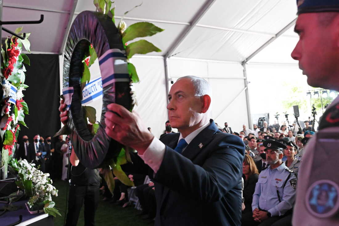 Israel's Prime Minister Benjamin Netanyahu, center, lays a wreath during a state memorial ceremony in memory of those killed in the Oct. 7, 2023, Hamas attack on Israel, at Mount Herzl Cemetery in Jerusalem, Monday, Oct. 5, 2026. (Debbie Hill/Pool Photo via AP) ADDITION: Adds context of memorial ceremony.