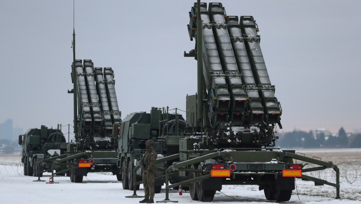 FILE PHOTO: Serviceman patrols in front of the Patriot air defence system during Polish military training on the missile systems at the airport in Warsaw, Poland February 7, 2023. REUTERS/Kacper Pempel