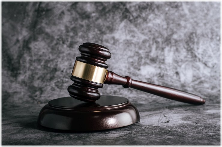 wooden judges gavel on table in a courtroom or enforcement office.