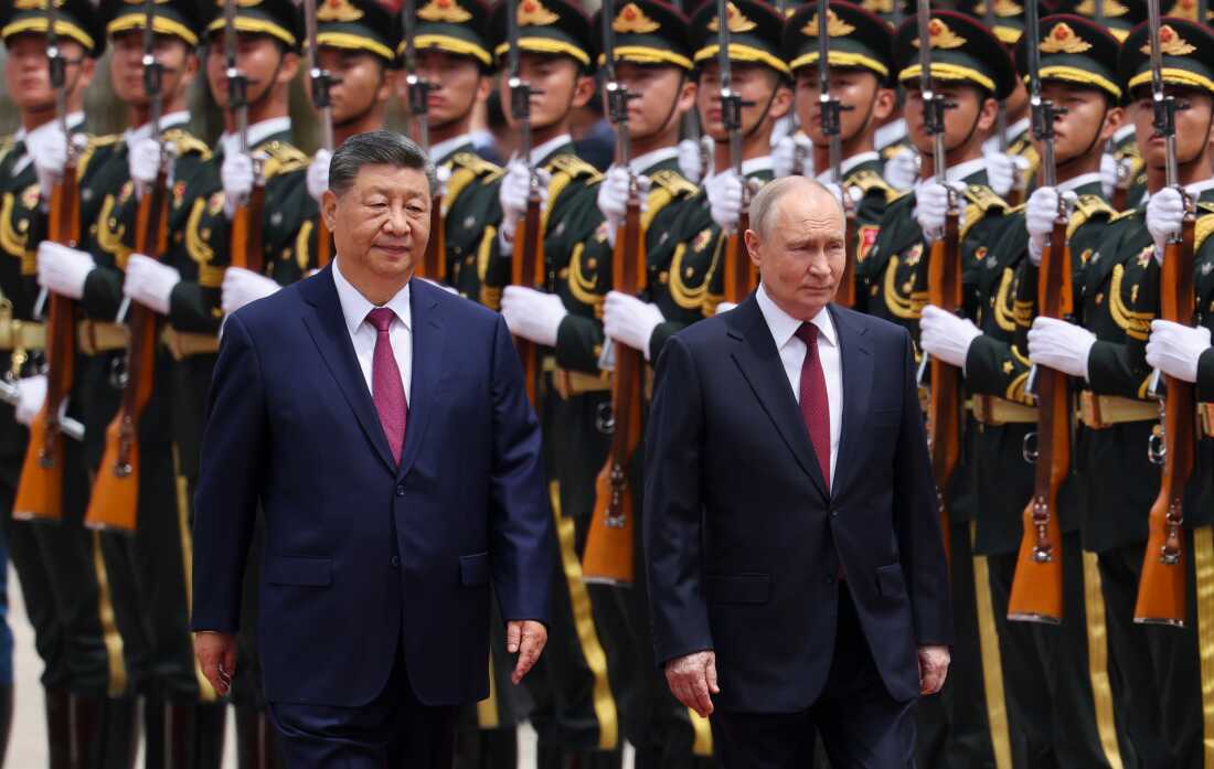 Russian President Vladimir Putin, right, and Chinese President Xi Jinping inspect an honor guard during a welcoming ceremony at the Great Hall of the People in Beijing Wednesday, May 20, 2026. (Maxim Shemetov/Pool Photo via AP)