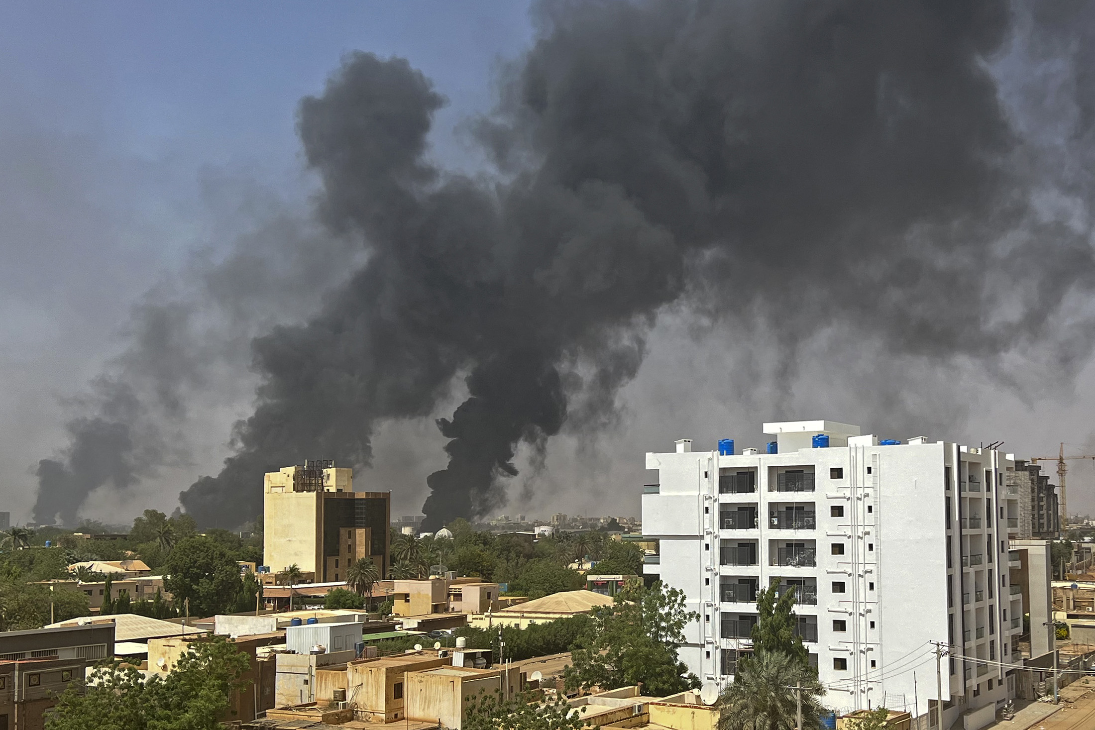 Smoke billows above residential buildings in Khartoum on April 16, 2023, as fighting in Sudan raged for a second day in battles between rival generals. - Violence erupted early on April 15 after weeks of deepening tensions between army chief Abdel Fattah al-Burhan and his deputy, Mohamed Hamdan Daglo, commander of the heavily-armed paramilitary Rapid Support Forces (RSF), with each accusing the other of starting the fight. (Photo by AFP) (Photo by -/AFP via Getty Images)