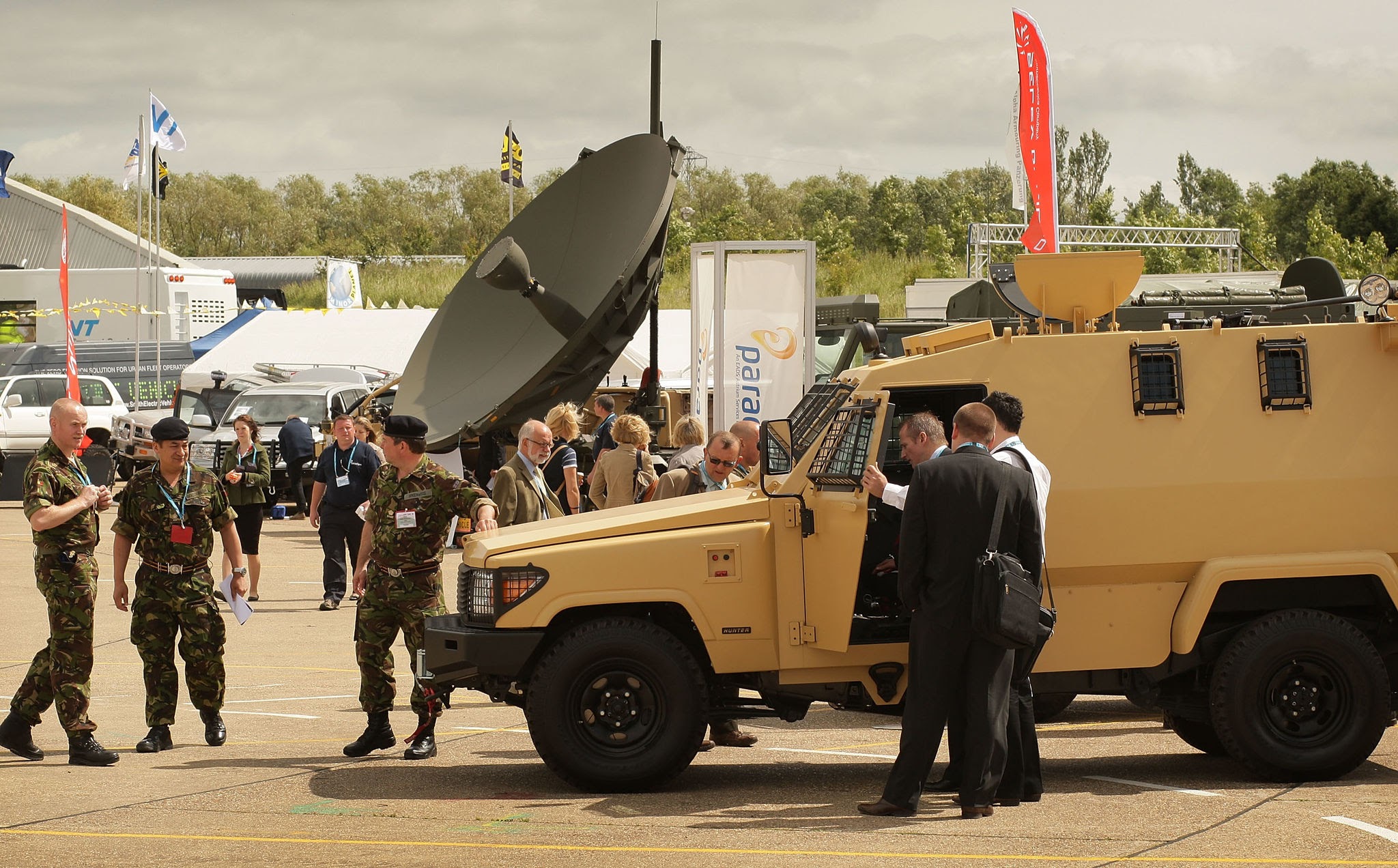 LONDON - JUNE 26:  Visitors look at exhibits at the Defence Vehicle Dynamics exhibition on June 26, 2008 at the Millbrook Proving Ground, England. More than 4,000 visitors come to look at over 200 companies displaying equipment and systems for military use.  (Photo by Peter Macdiarmid/Getty Images)