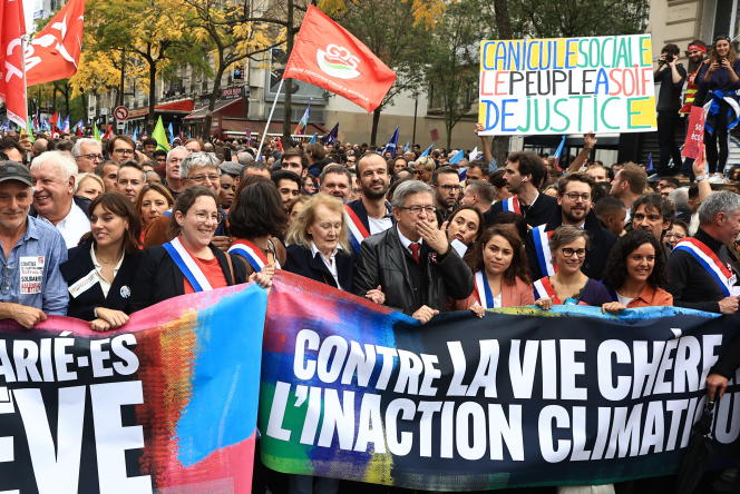 French leftwing politician Jean-Luc Melenchon, center, leads a protest march against the high cost of living and climate inaction in Paris, France, Sunday Oct. 16, 2022. Marchers are demanding wage increases, greater taxation of windfall profits and other steps to lessen the bite of rising inflation, heeding the call of left-wing parties and trade unionists hoping to crank up pressure on the government of French President Emmanuel Macron. (AP Photo/Aurelien Morissard)