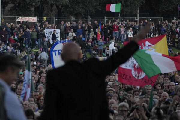 Demonstrators listen to speakers during a protest against restrictions for the unvaccinated, at Rome Circus Maximus, Saturday, Nov. 20, 2021. With infections spiking again despite nearly two years of restrictions, the health crisis increasingly is pitting citizen against citizen — the vaccinated against the unvaccinated. (AP Photo/Alessandra Tarantino)