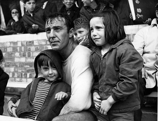 Footballer Jimmy Greaves of Tottenham Hotspur watches a football match with his children.  Original Publication: People Disc - HF0491   (Photo by William Vanderson/Getty Images)