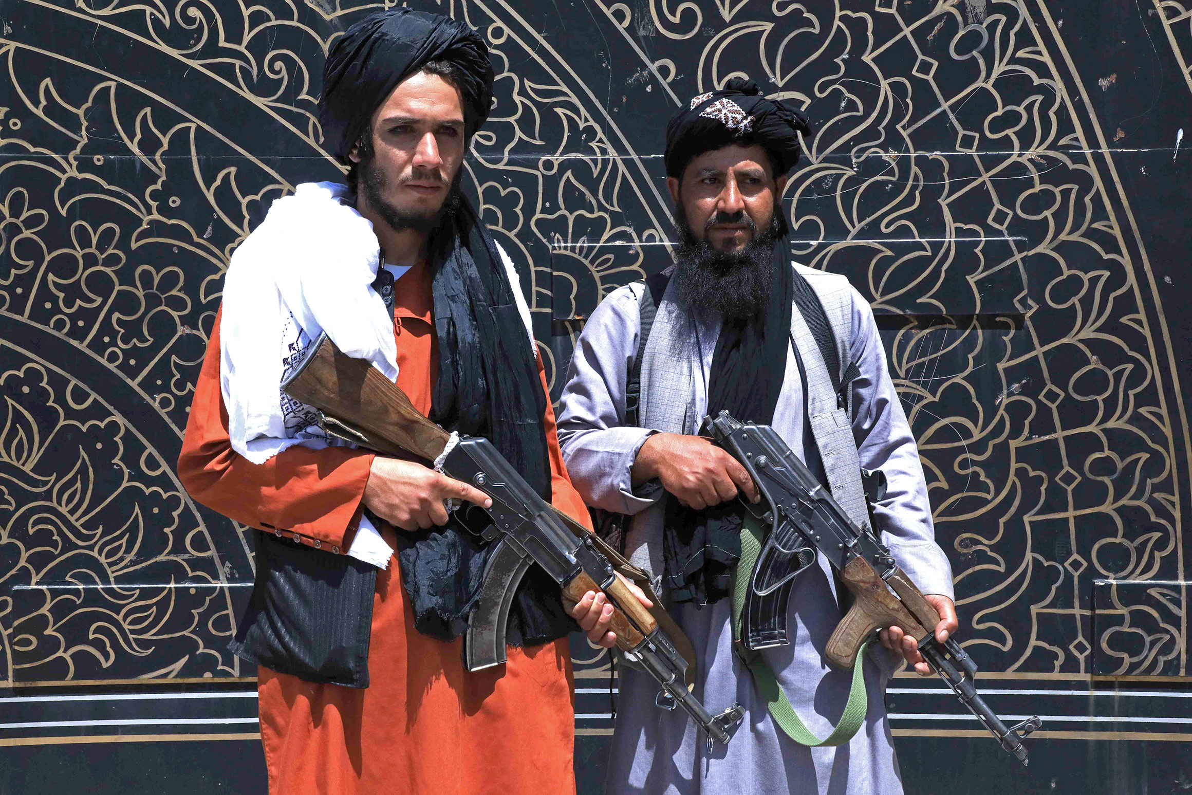 Taliban fighters stand guard in front of the provincial governor's office in Herat on August 14, 2021. (Photo by - / AFP) (Photo by -/AFP via Getty Images)