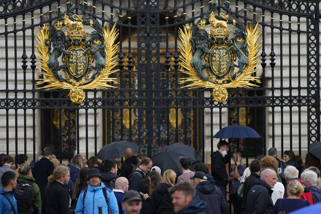 People gather outside Buckingham Palace in London, Thursday, Sept. 8, 2022. Buckingham Palace says Queen Elizabeth II has been placed under medical supervision because doctors are &quot;concerned for Her Majesty's health.&quot; Members of the royal family traveled to Scotland to be with the 96-year-old monarch. (AP Photo/Frank Augstein)